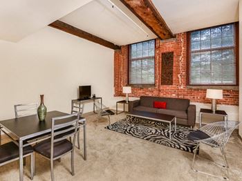 a living room with a couch table and chairs at Bigelow Commons, Enfield, CT
